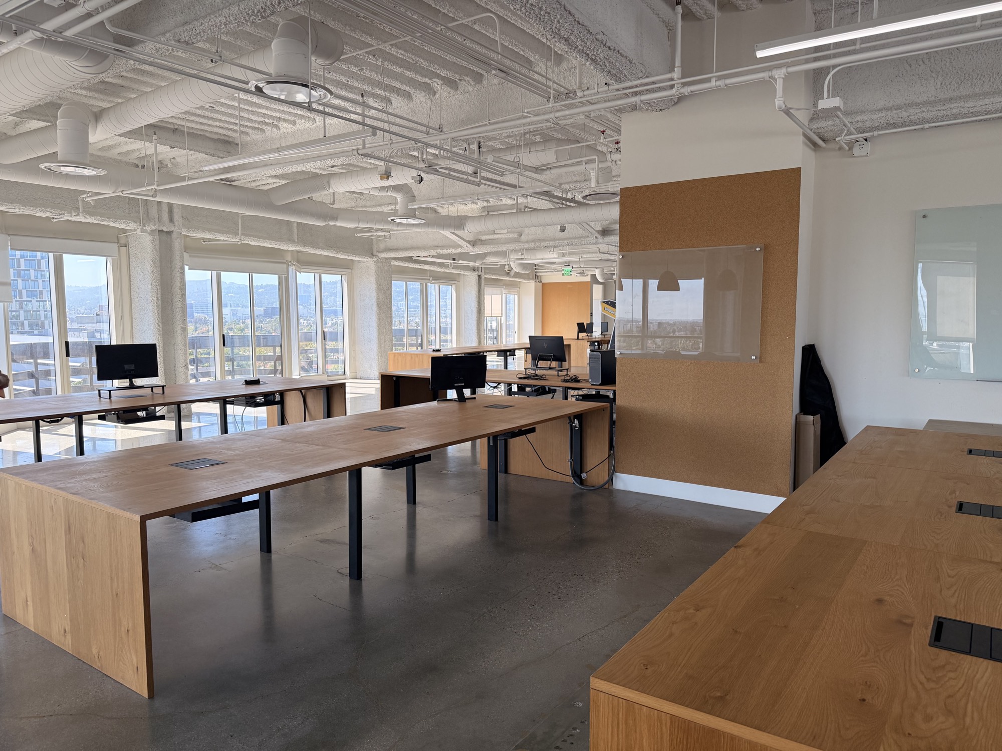 Open studio with standing desks and floor-to-ceiling windows