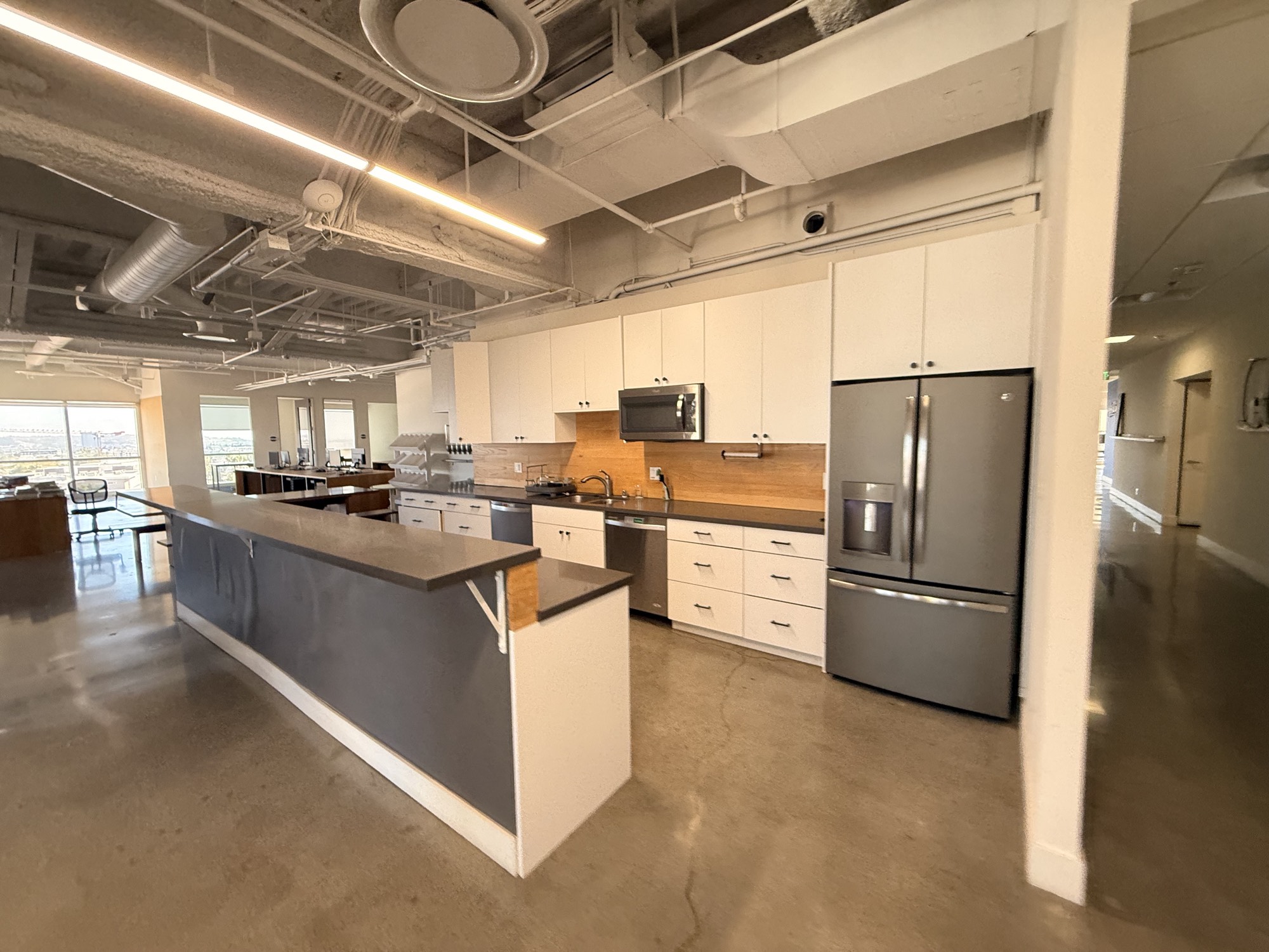 Full kitchen with island, fridge and seating